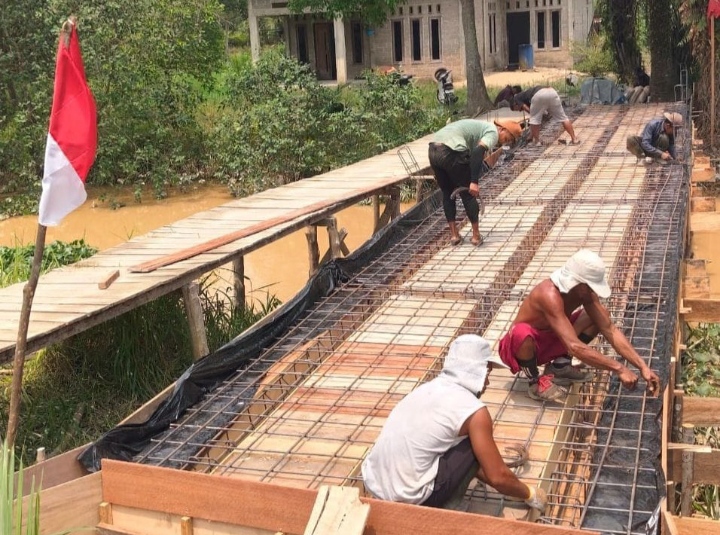 Saling Bekerjasama Antara Warga dan Babinsa Koramil 01/Rengat Bersama-sama Bangun Jembatan Garuda